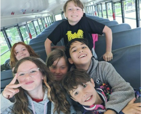 Students smiling together for a group selfie