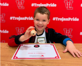 Student showing off a #TrojanPride award
