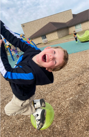 Student playing outdoors on the field