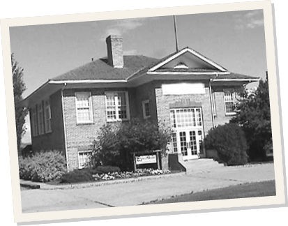 A black and white photo of the original Whitmore Lake school building.
