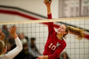 Rachel Speck blocks the volleyball during a game at Jackson Lumen Christi Catholic School. 