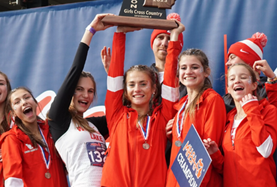 Girls cross country team winning a championship